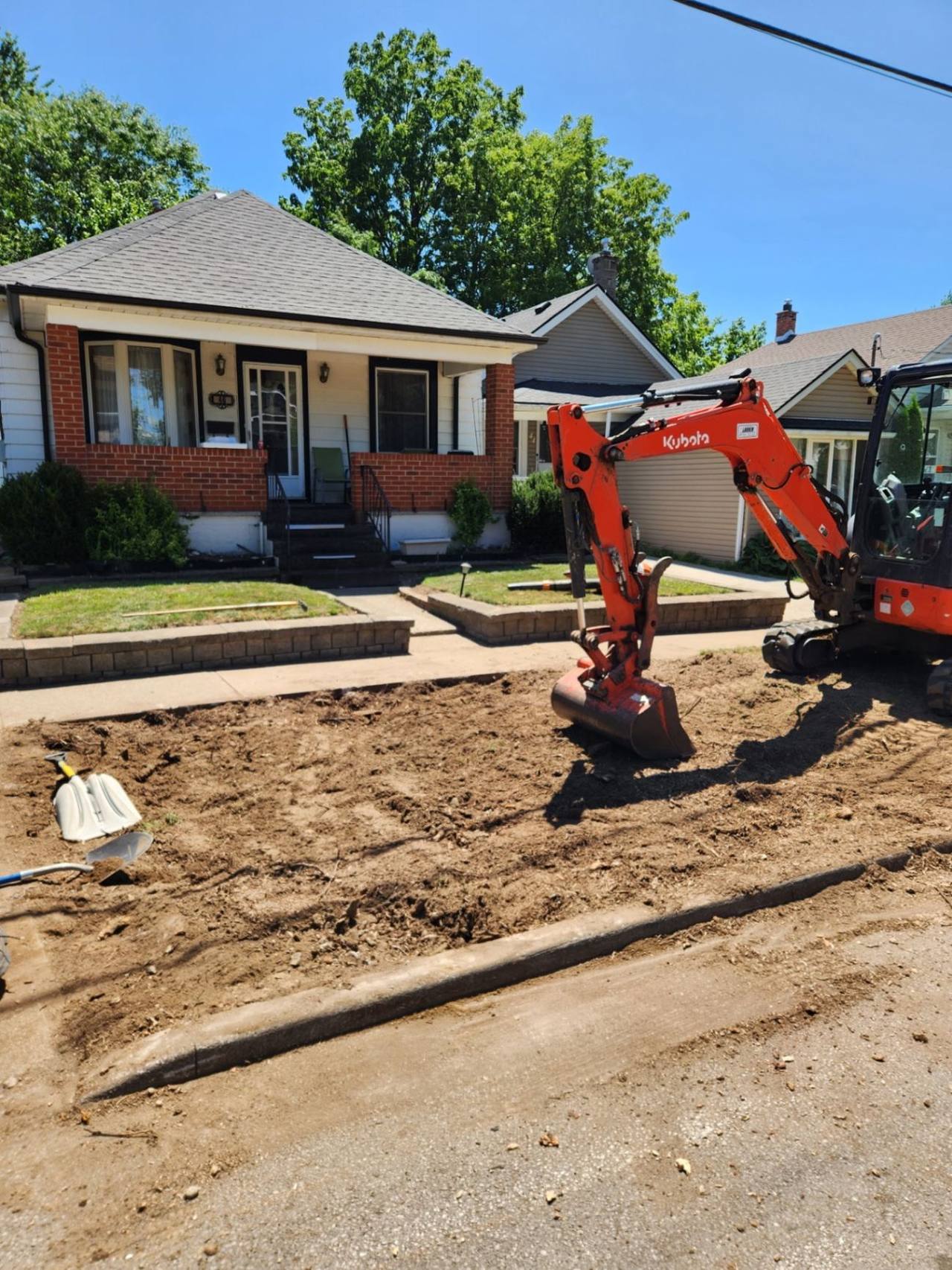 Finished site after stump grinding and excavation work in a front yard